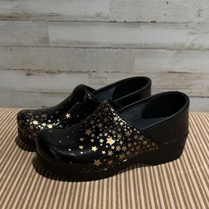 Dansko Black and Gold Star Pattern Clogs